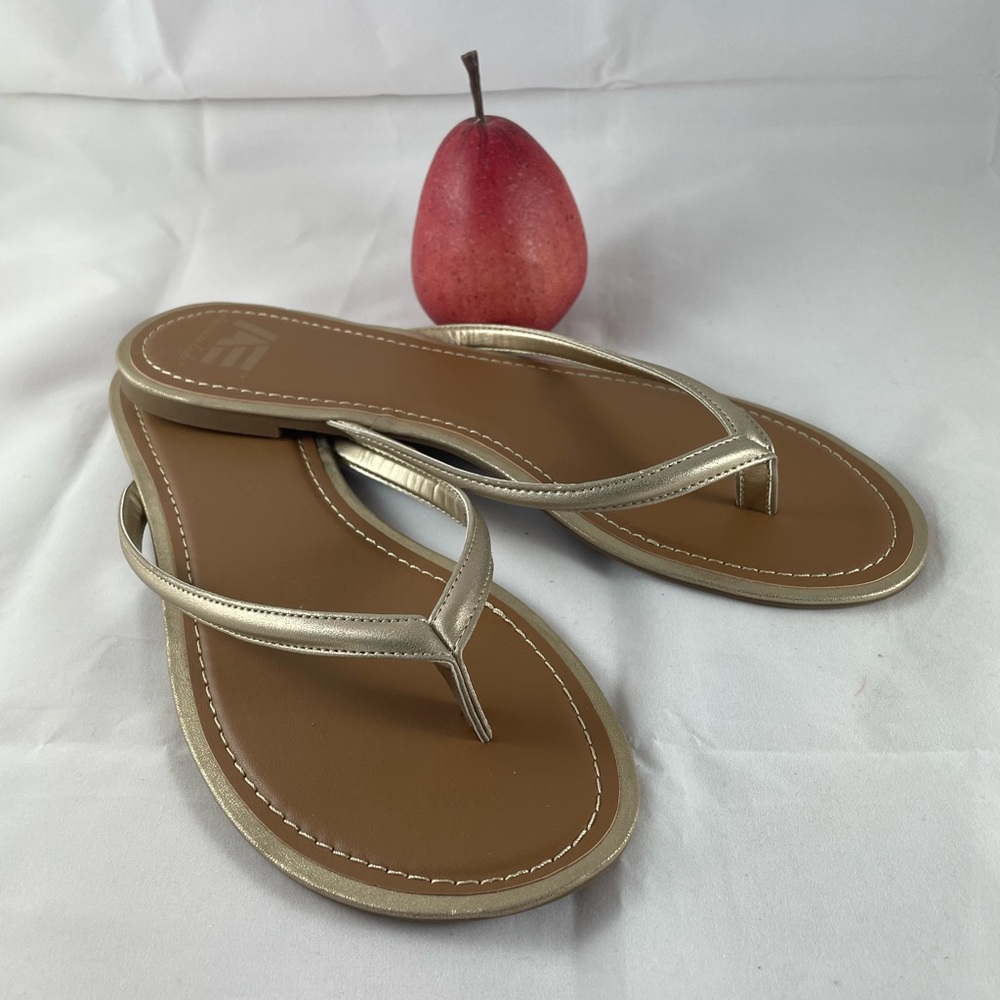 Gold sandals, flats, or thongs, size 12. Never worn.
